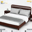 A dark brown wooden twin bed frame with a slatted headboard, styled with white and gray bedding, white duvet, and gray runner, shown on a white background with brand overlays.